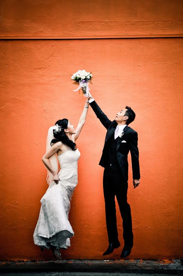 mauritius-beach-wedding-photographer-bride-groom-red-wall-jump.jpeg