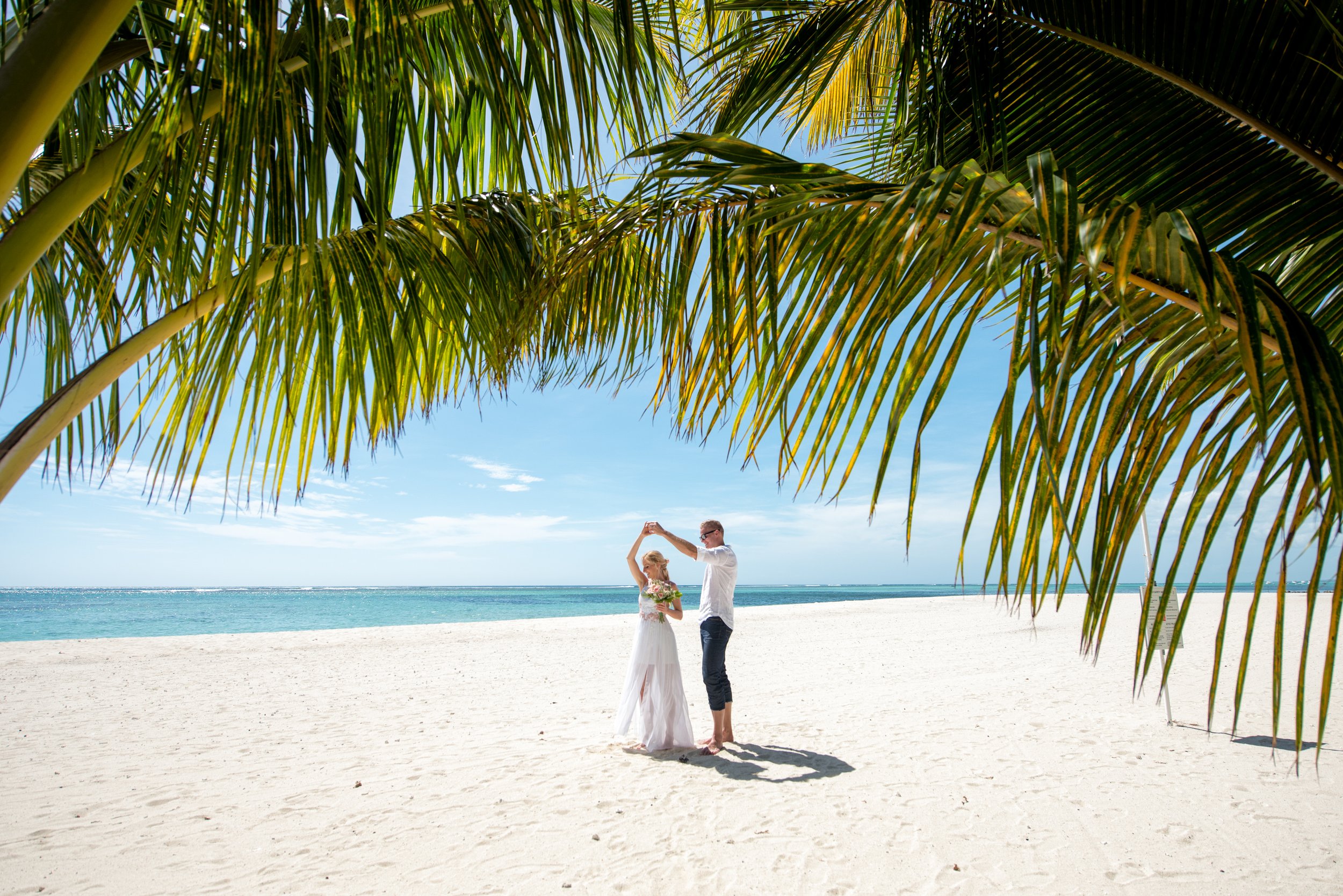 mauritius-beach-wedding-photographer-bride-groom-dancing-under-palm.jpg