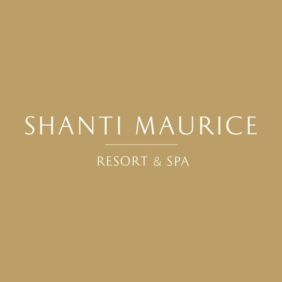 Logo for Shanti Maurice Resort & Spa on a beige background.