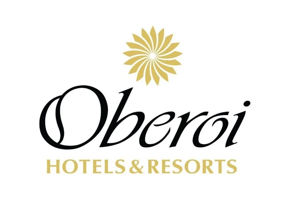 Logo for Oberoi Hotels & Resorts with a gold floral design above the word 'Oberoi' in black and 'Hotels & Resorts' in gold.