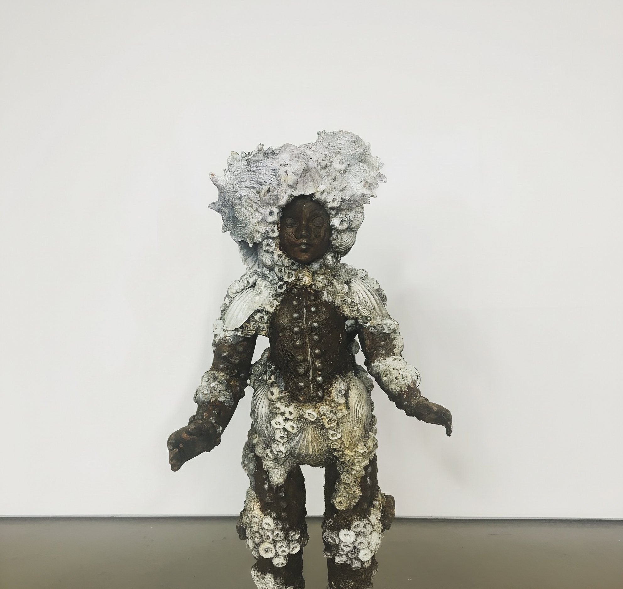 Adam Cooley, mixed media sculpture of a human figure constructed from shells, coral, and natural materials.