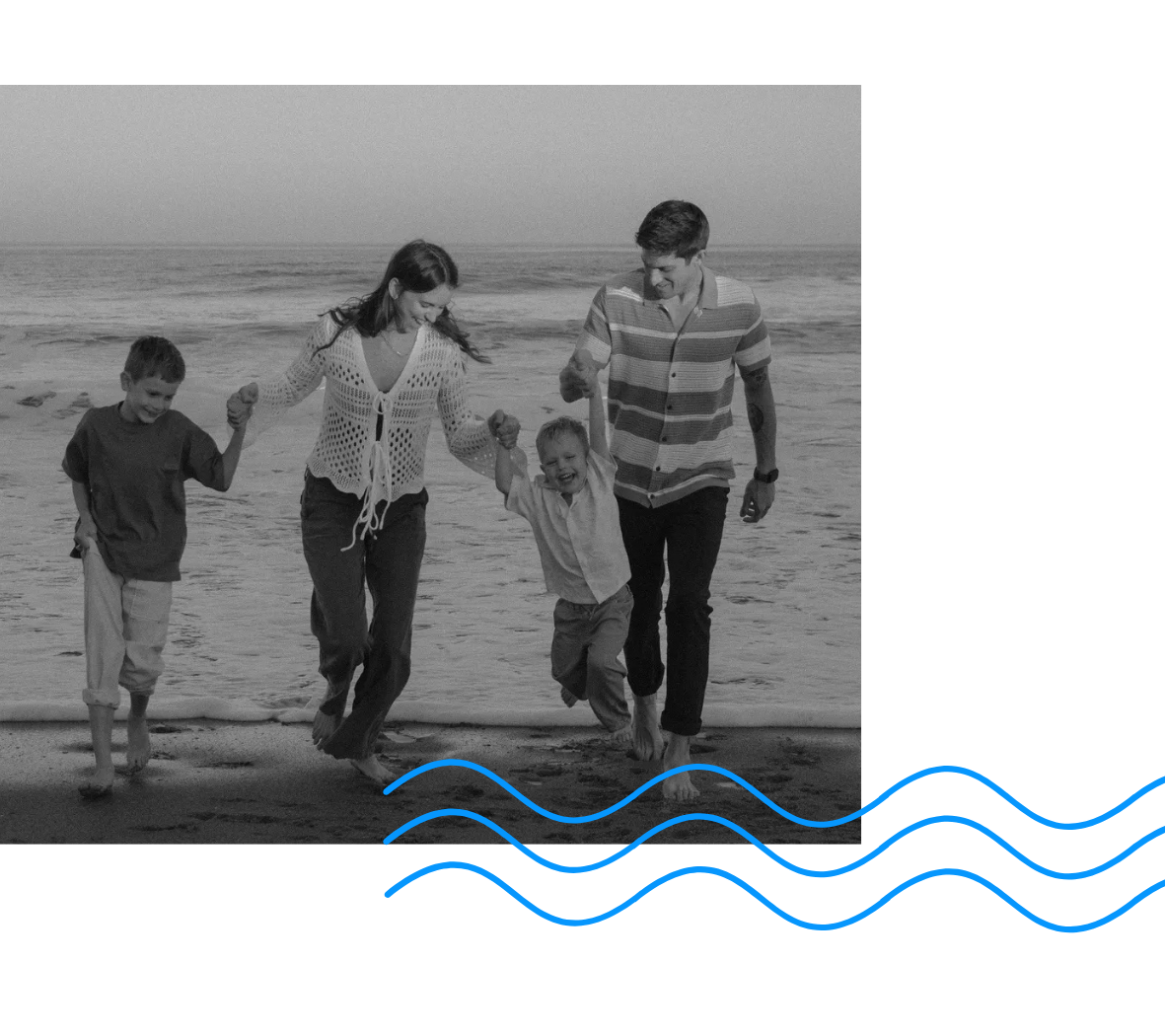 A family of four, including two children and two adults, walking along the beach holding hands. The child in the middle is being lifted by the adults, and all are smiling. The waves are gently approaching the shore, and the scene has a mix of black-and-white with some blue wave accents at the bottom.