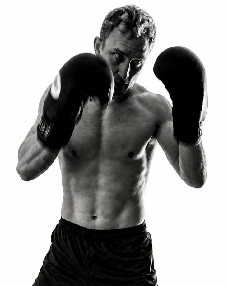 Will Ratliff a life coach in Austin, in a fighting stance, with boxing gloves.