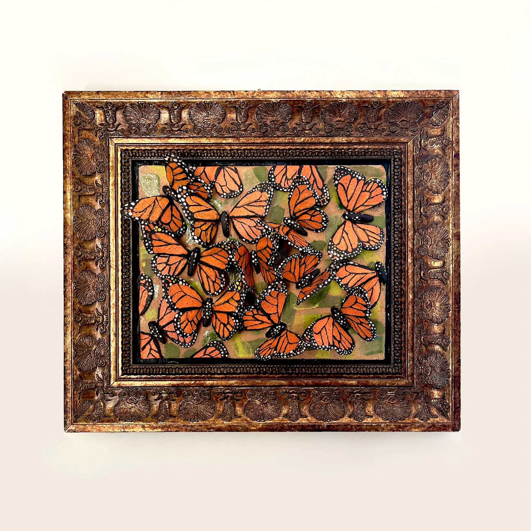 Decorative framed artwork featuring orange and black monarch butterflies.
