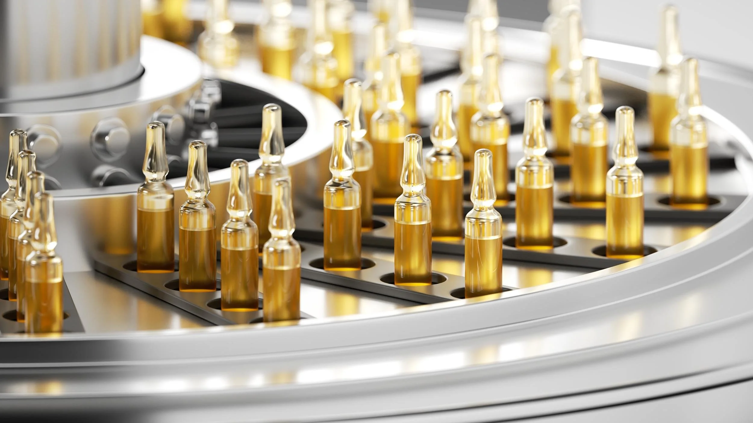 Close-up of a medical laboratory device with small glass vials filled with a yellow liquid, arranged in a metal rack.