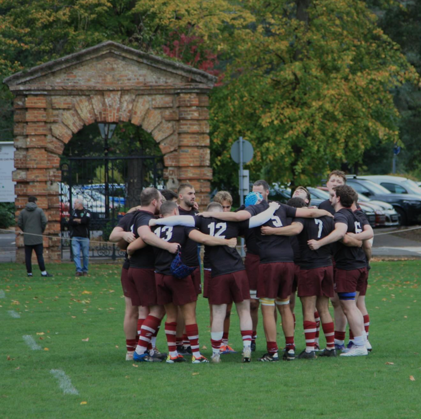 The Old Georgian RFC 1st XV gather in a huddle on their pitch at St George's College Weybridge ahead of a big game