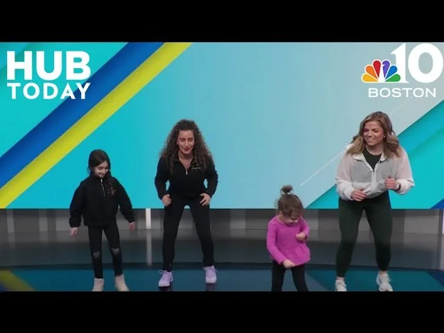 Four women and children participating in an indoor fitness or dance class, with a blue and teal background displaying 'HUB TODAY' and 'NBC 10 BOSTON' logos.