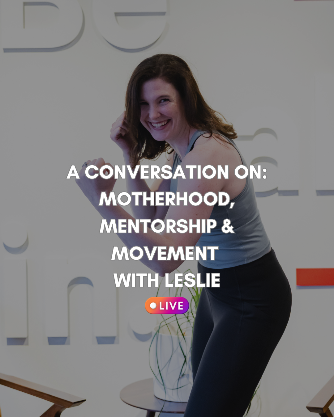 A woman smiling and posing with a flexed arm in an office setting with a decorative wall and potted plant, overlaid with text about a live discussion on motherhood, mentorship, and movement with Leslie.