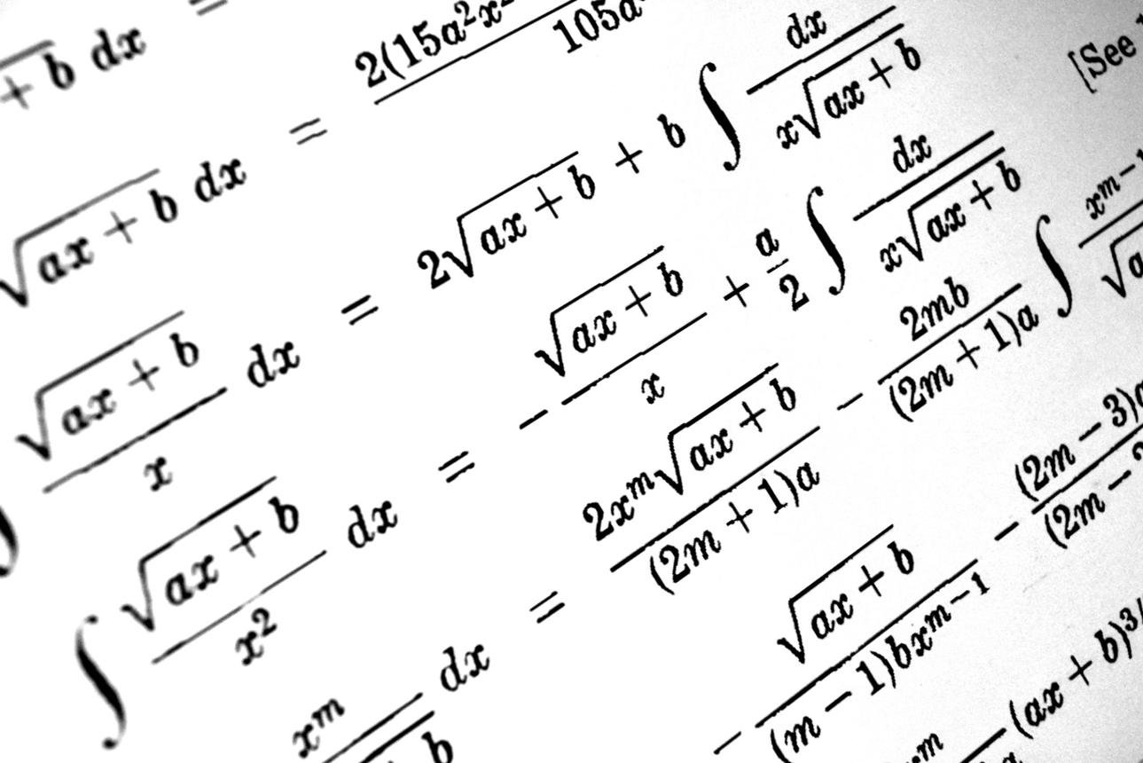Close-up of a page showing complex mathematical equations involving integrals and square roots.