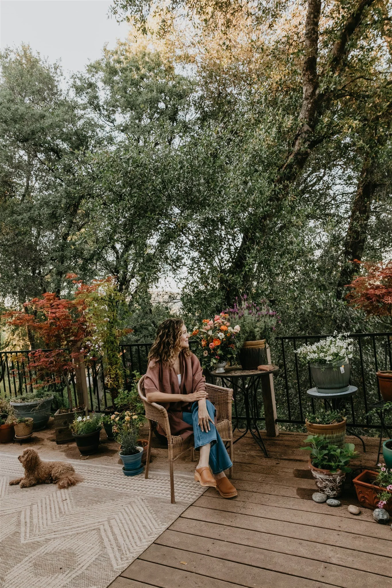 Rachael Courtier seated outdoors in a peaceful setting for somatic therapy for complex trauma