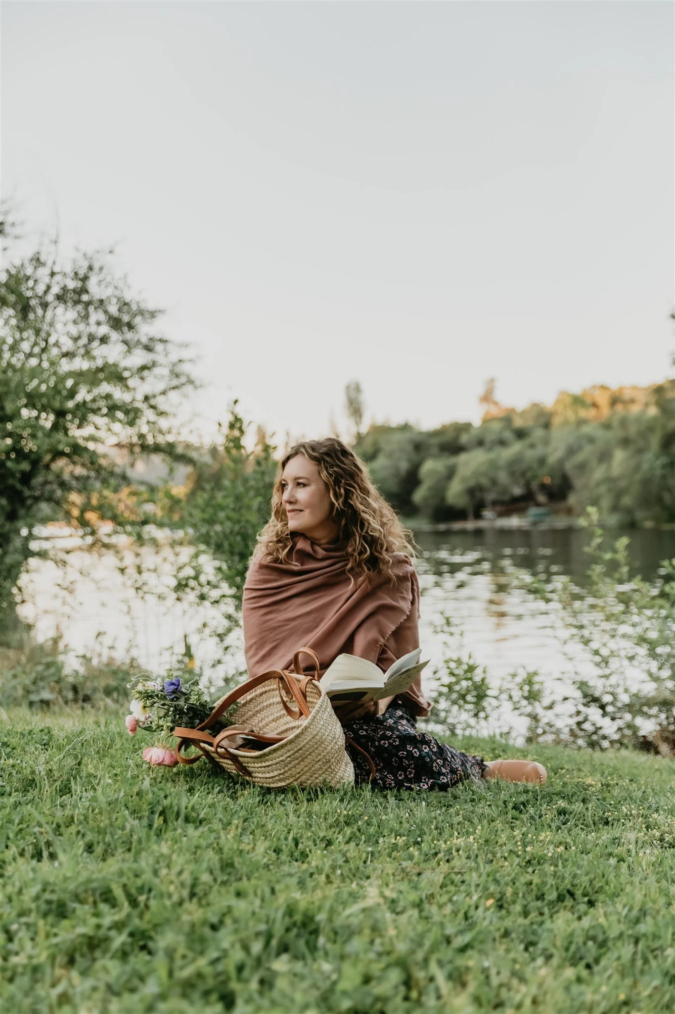 Rachael Courtier reading by the lake in a peaceful setting for psychedelic assisted therapy