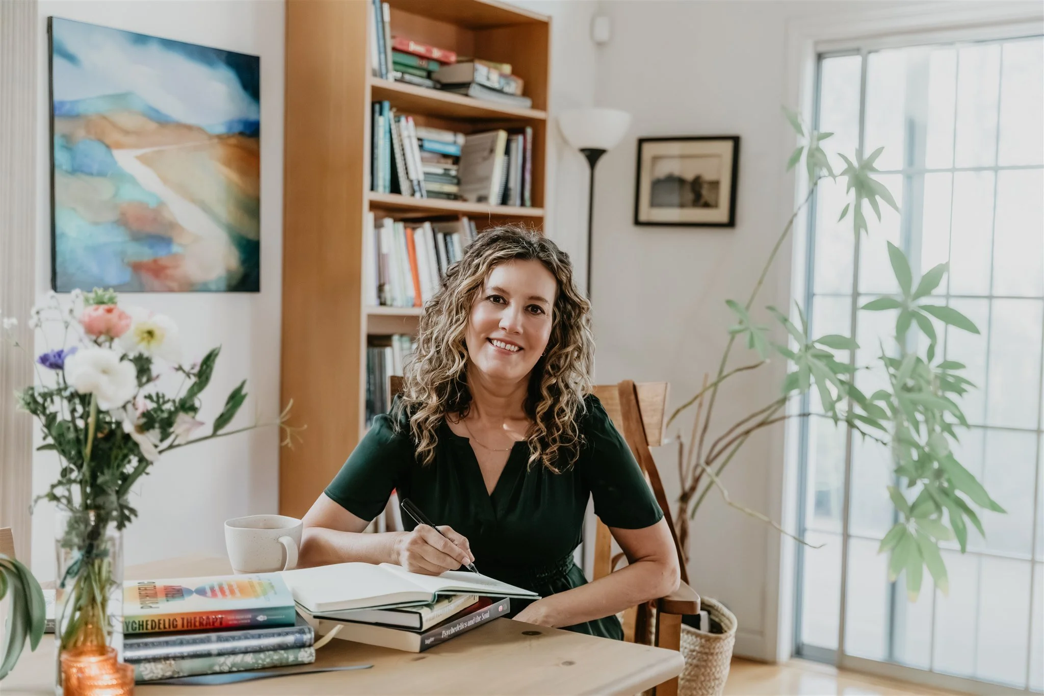 Rachael Courtier, psychotherapist in CA, writing in her calm therapy office with books and natural light