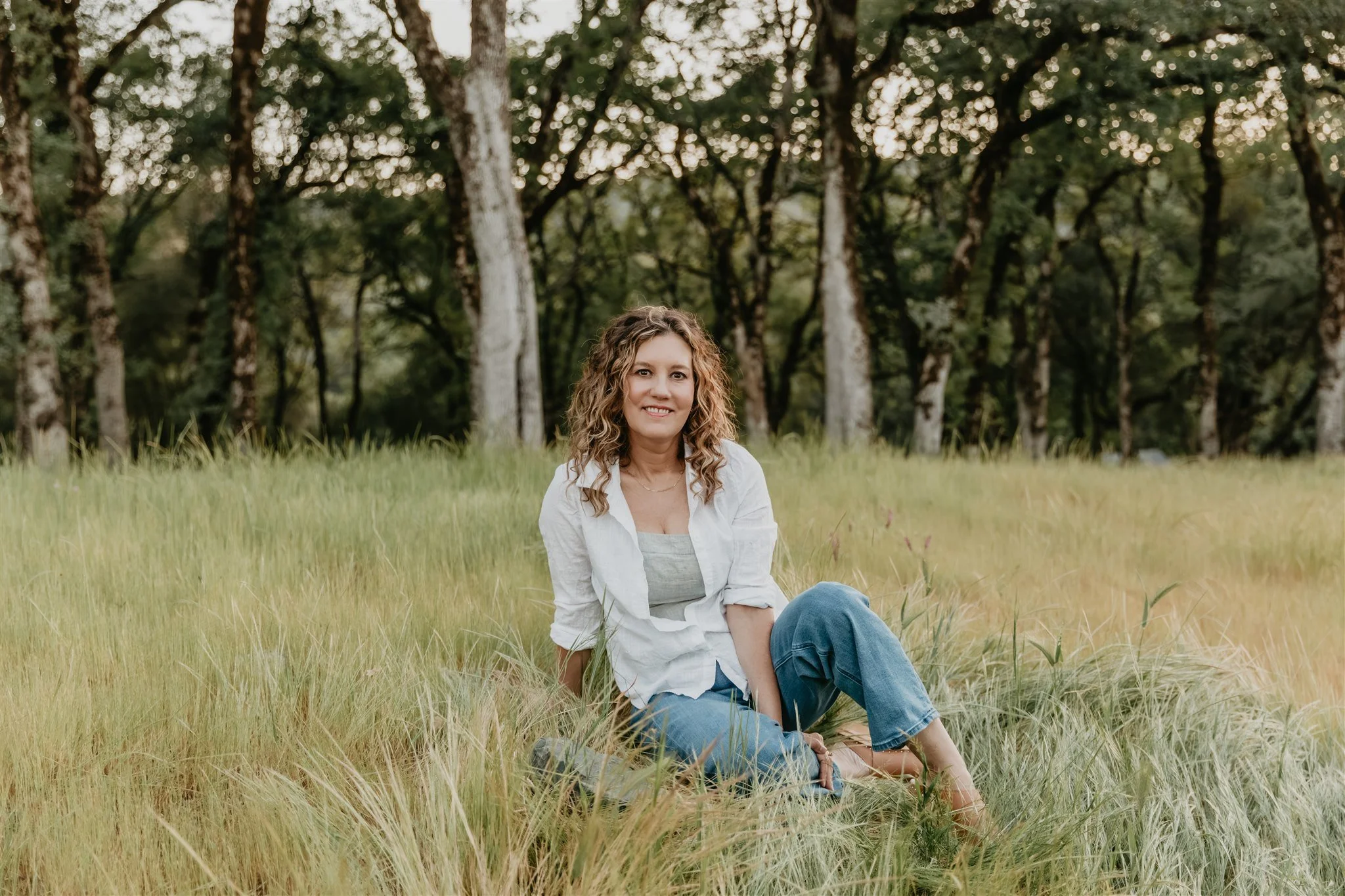 Rachael Courtier seated in nature, offering support for ADHD relationship struggles