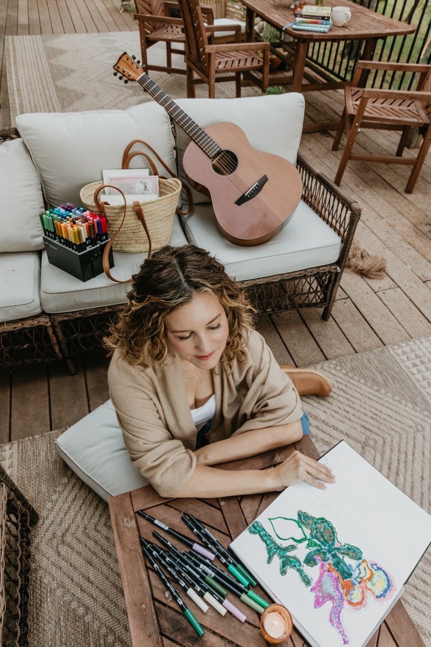 Rachael Courtier journaling outdoors with creative tools used in psychedelic assisted therapy