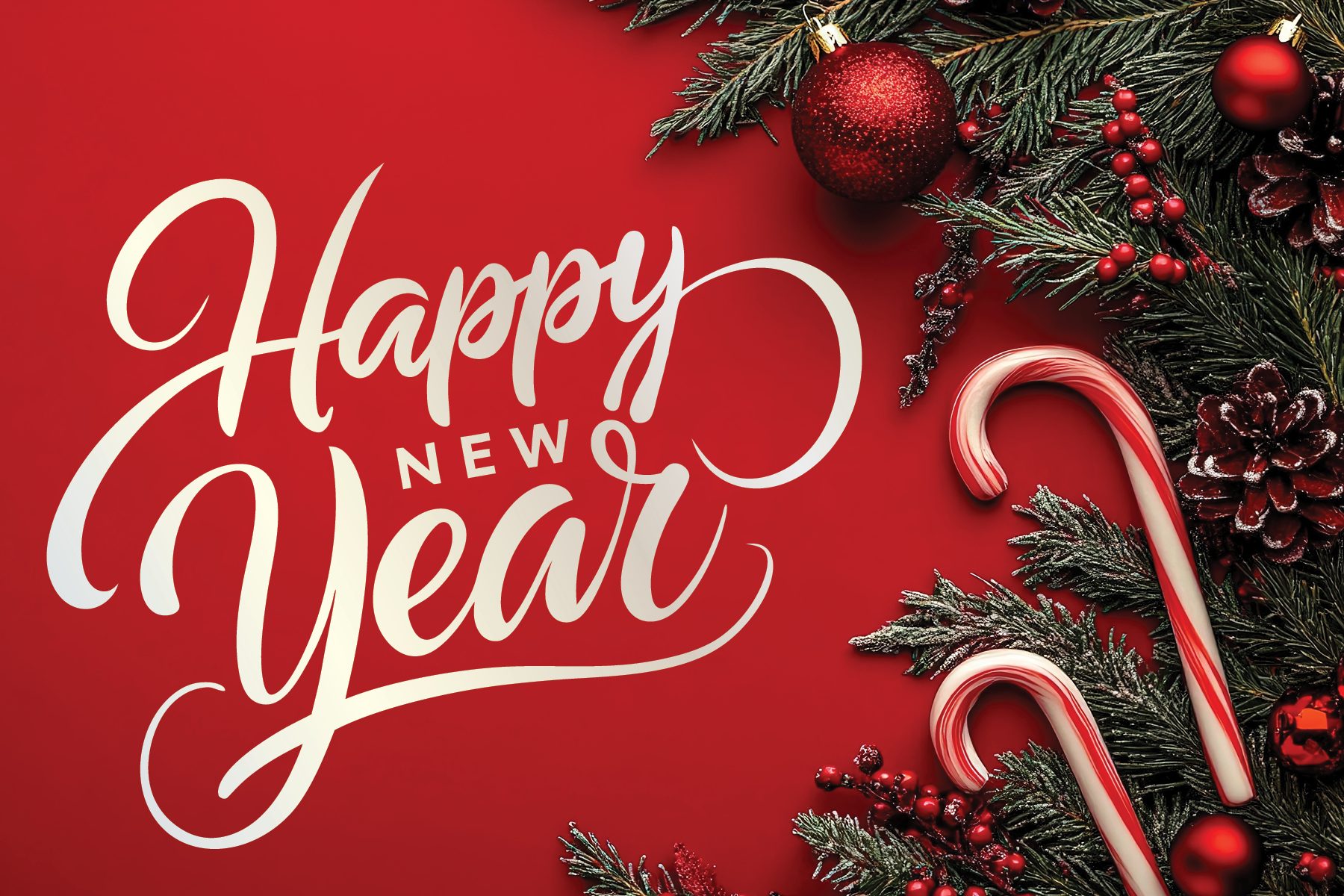 A festive holiday greeting card featuring the text 'Happy New Year' in elegant white script. The background is red with Christmas decorations including pine branches, red ornaments, pinecones, candy canes, and red berries arranged along the top and r
