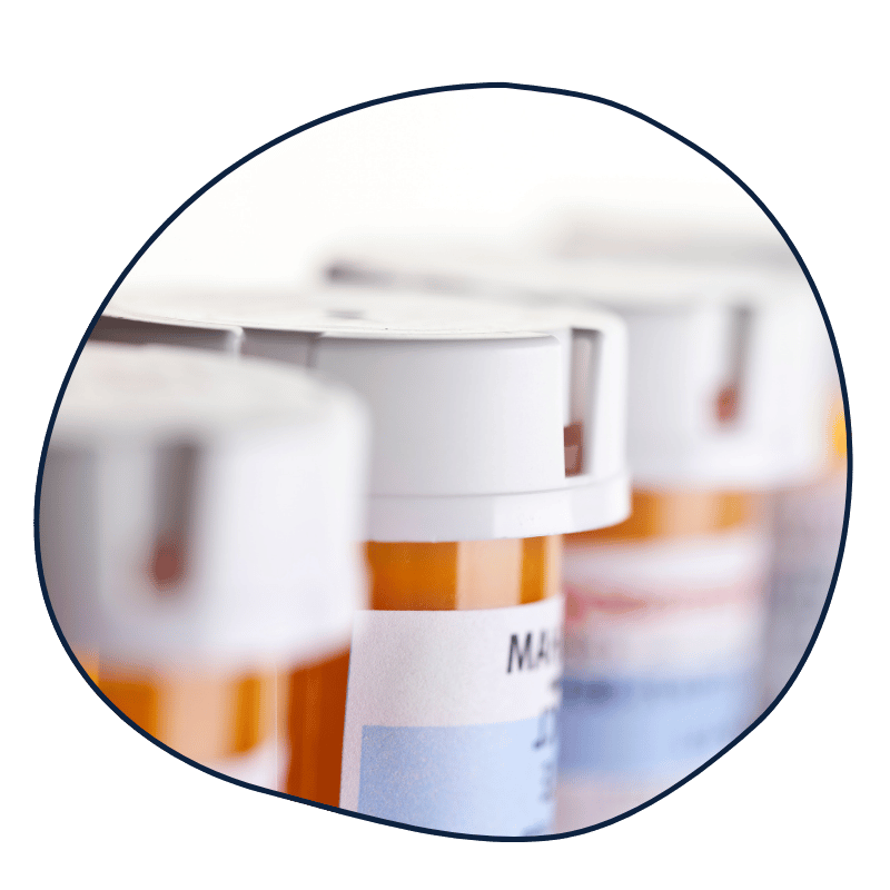 Close-up of prescription medication bottles with white caps and labels.