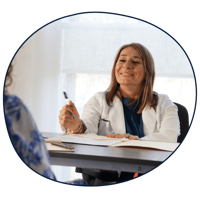 Mandie Romero, P.D. consulting with a woman about menopause