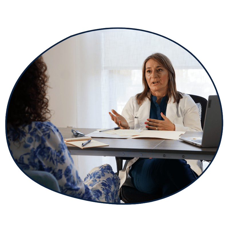 Mandie Romero, P.D. consulting with a patient about stress and nervous system support.
