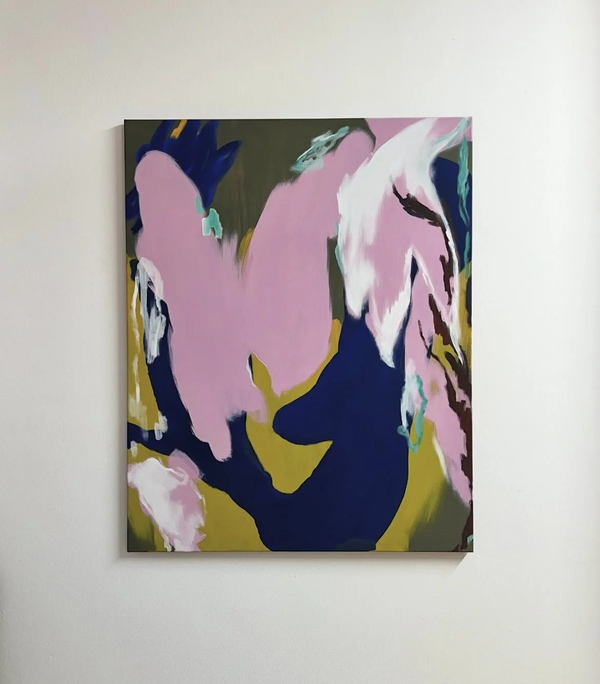 Abstract painting of a white horse with pink, green, and dark blue accents on a wall.
