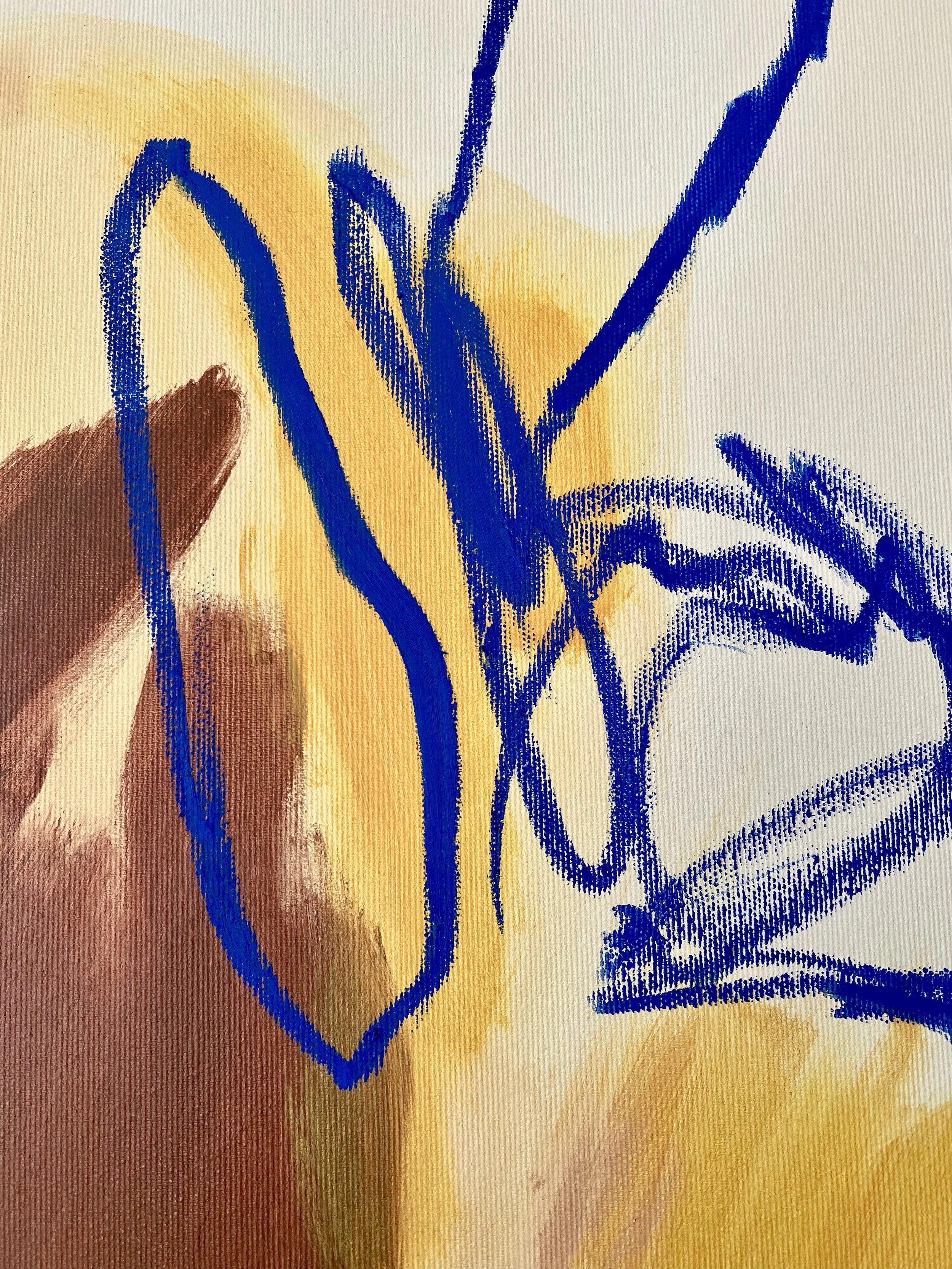 Close-up of an abstract artwork with yellow and brown background, overlaid with blue graffiti-style lines and shapes.
