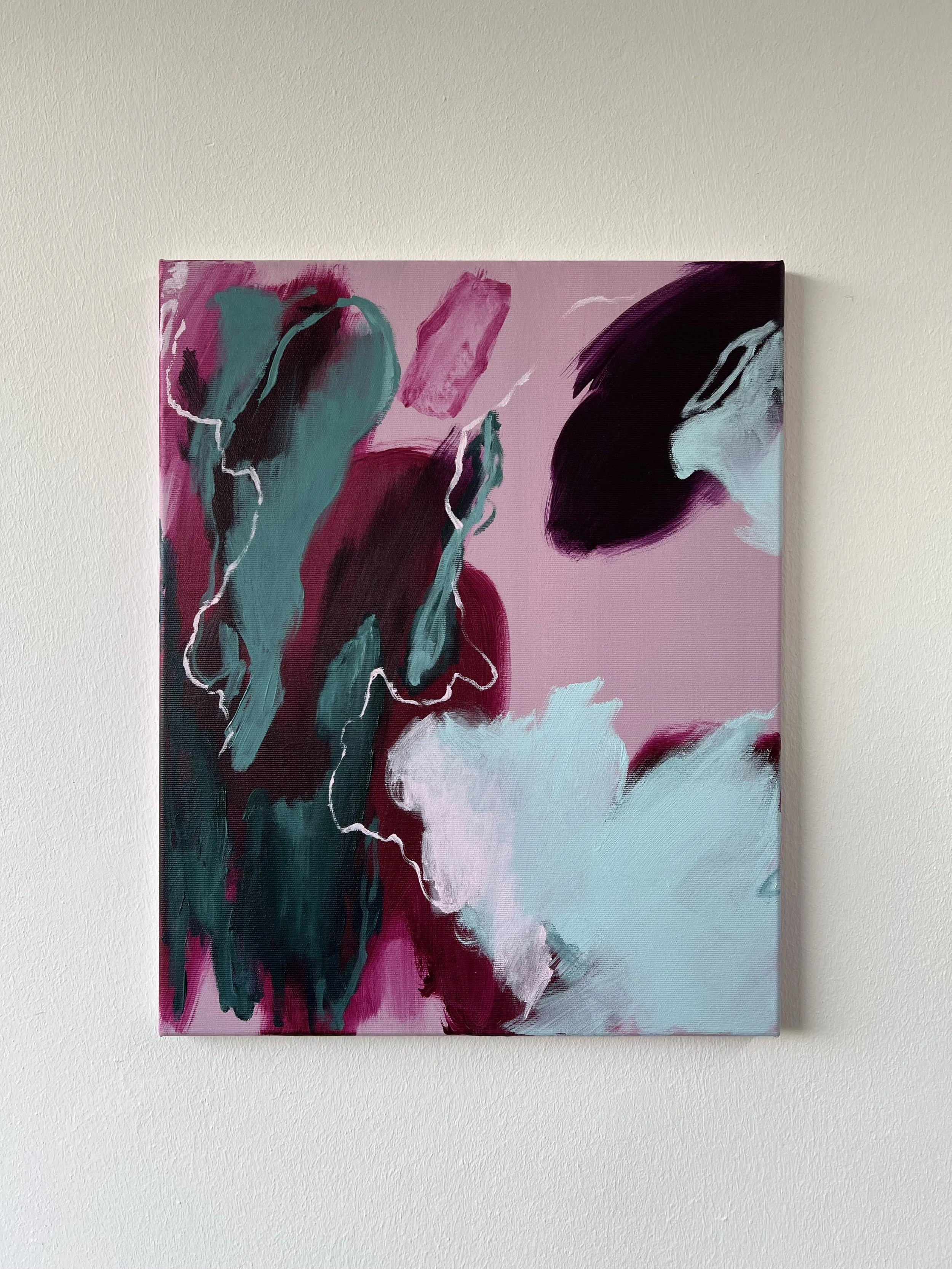 Abstract painting with pink, teal, black, and white brushstrokes on a canvas.