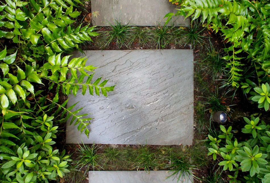 Random rectangular Pennsylvania Blue Flagstone stepping pads create a natural bridge connecting the garden.