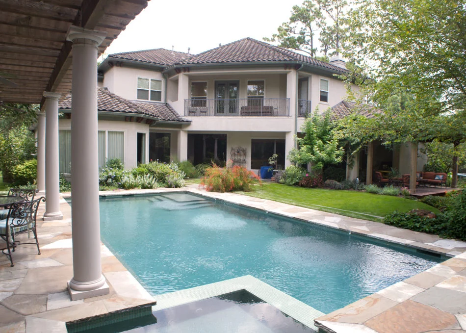 Flagstone was used to deconstruct the sharp edge of the pool which now leads to a circular stone path acting as a fulcrum for the veranda.