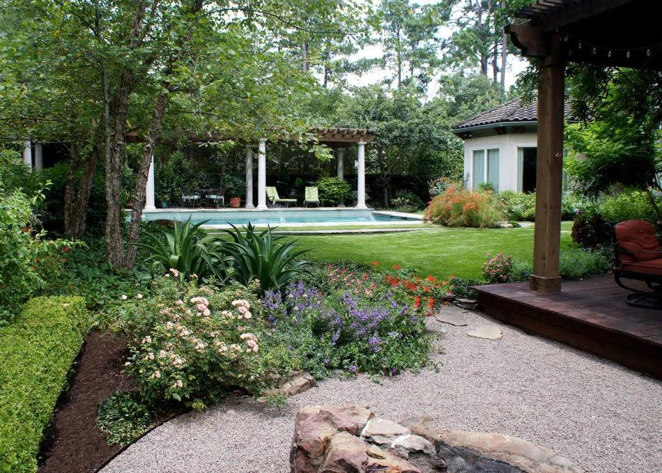 A natural moss rock boulder was custom made with a disappearing fountain for the center of the Italian rock garden while zoysia zorro grass provides a lush blanket for the lawn.