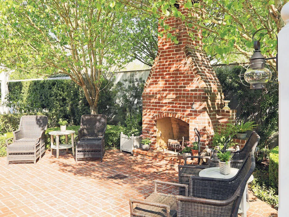 A red brick fireplace adds extra detail to this New England style home in Houston, TX.