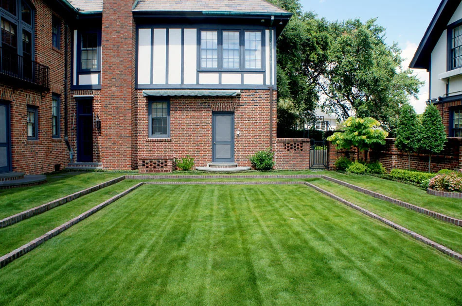Eagleston Hollies, affectionately pruned to jewel-shapes, add visual interest to the view from the grand terraced lawn.