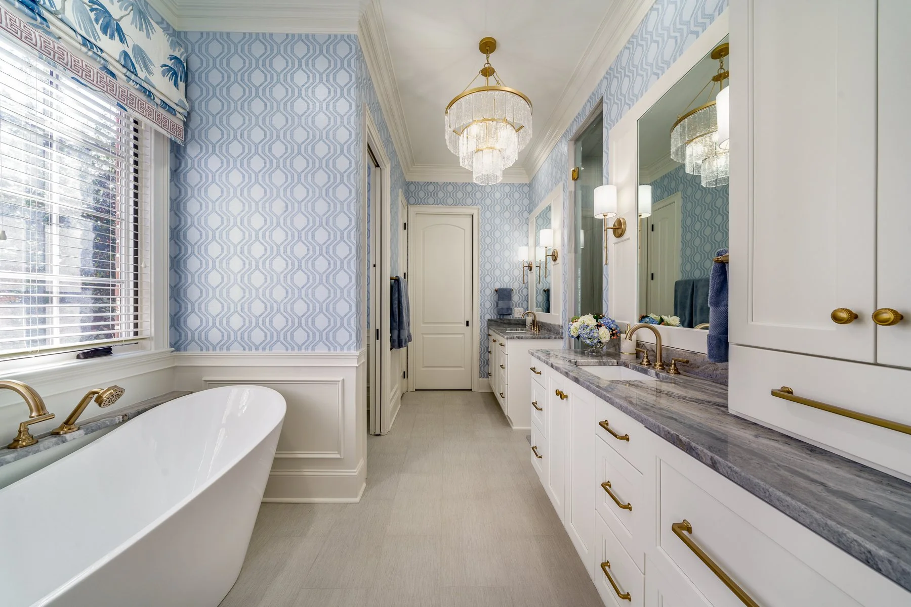 New construction bathroom design with blue wallpaper and freestanding soaking tub