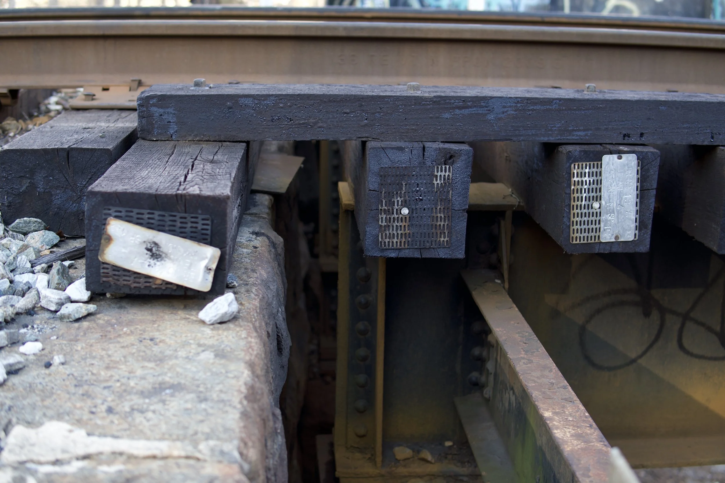 Close-up of railroad tracks with wooden ties and metal fasteners.