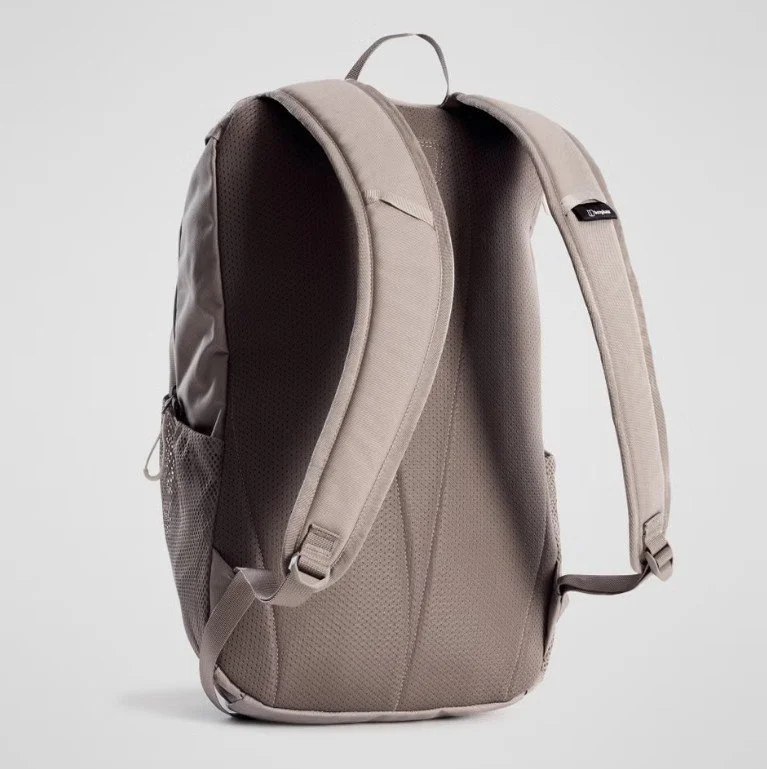 A beige backpack with padded shoulder straps and a handle on top, standing against a plain background.