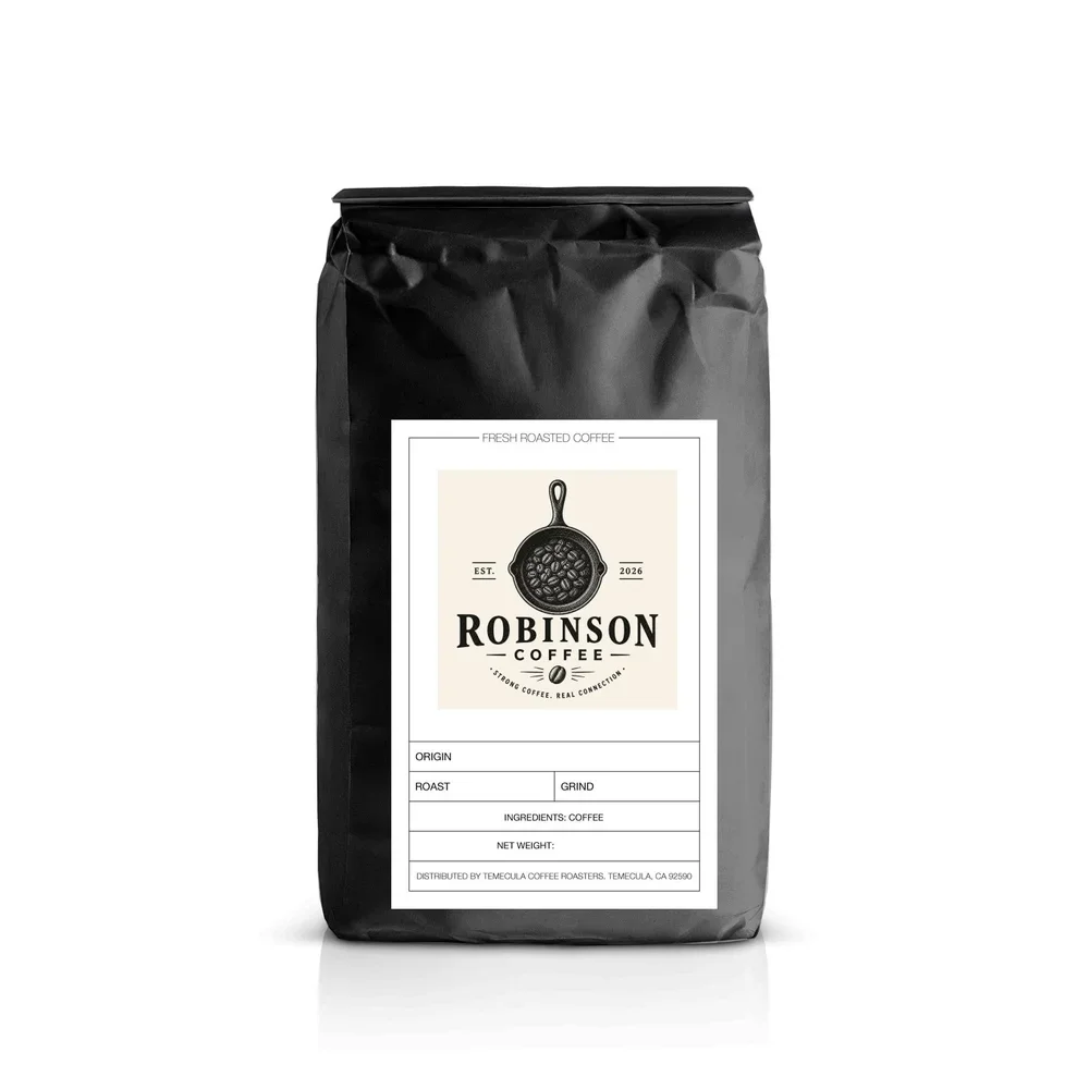 A black bag of Robinson Coffee with a white label featuring a skillet with coffee beans, and sections for origin, roast, grind, ingredients, and net weight.