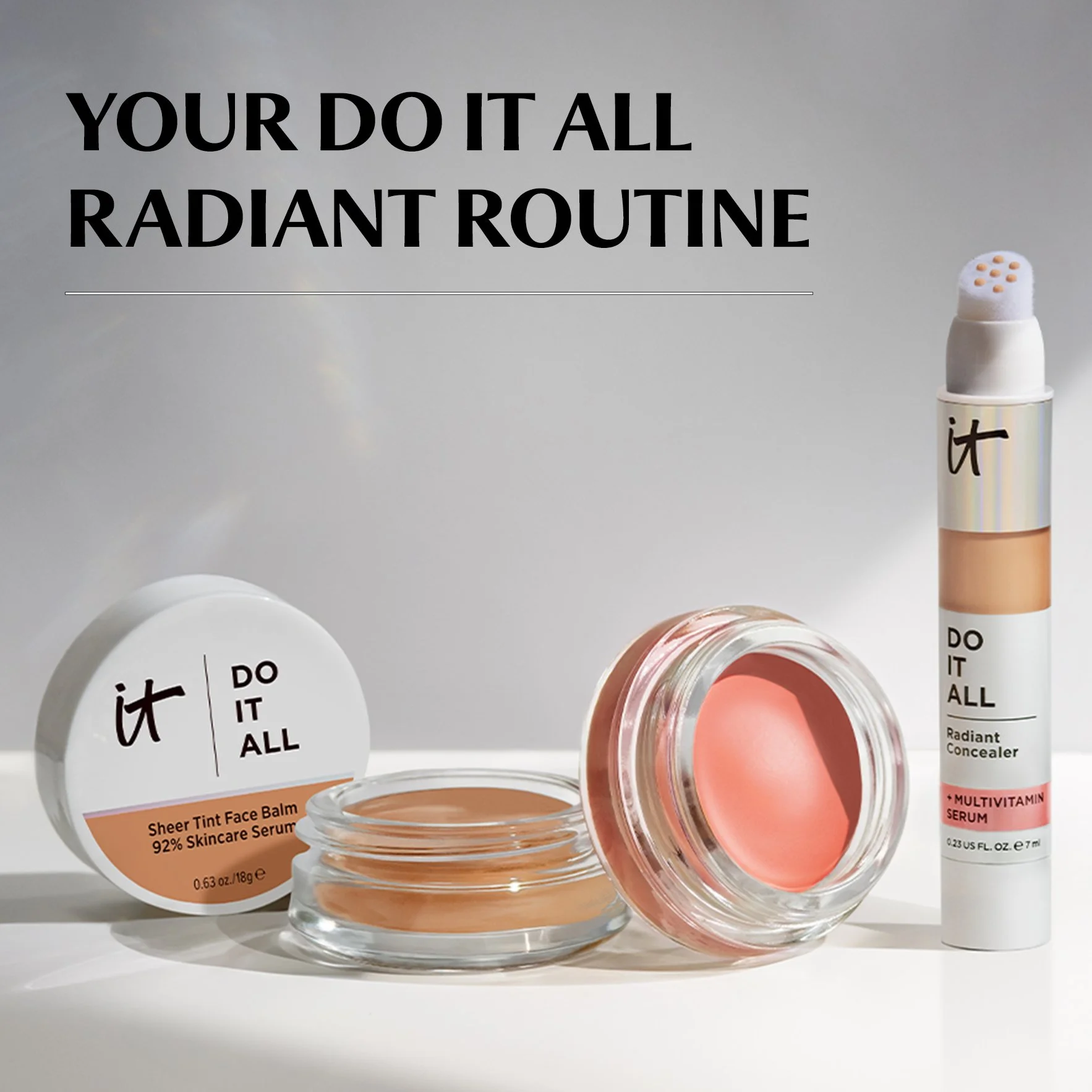 Display of skincare products from it Cosmetics, including a multi-vitamin serum, a sheer tint face balm, and a radiant concealer, with clear packaging and a clean, minimalist background.
