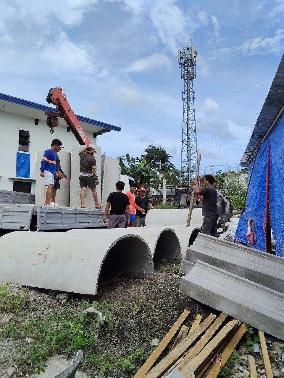 Group of mathanog precast workers with GFRC Precast column using a boom truck.