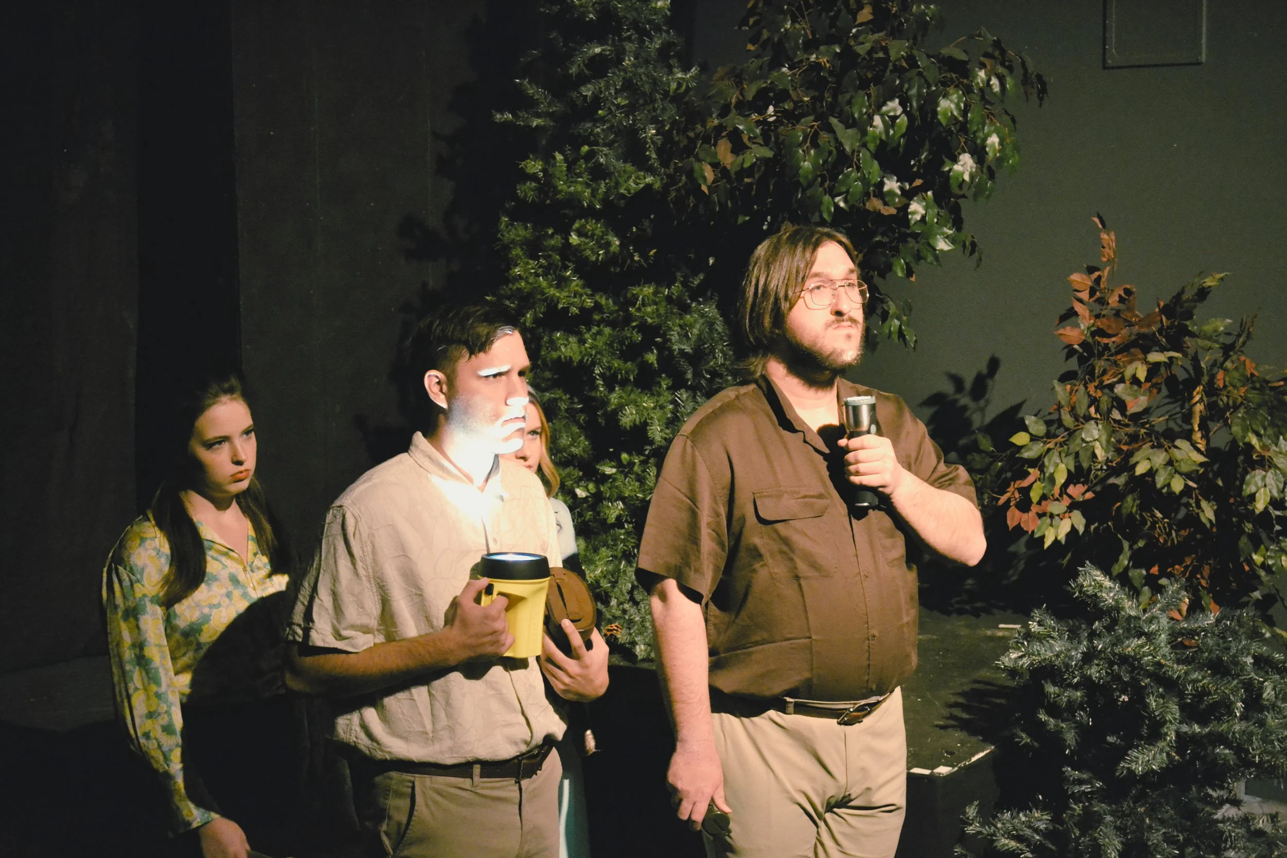 Reese Tabb, Kenny Sibley Jr., and Caleb Friend scour the woods with flashlights for The Howler.