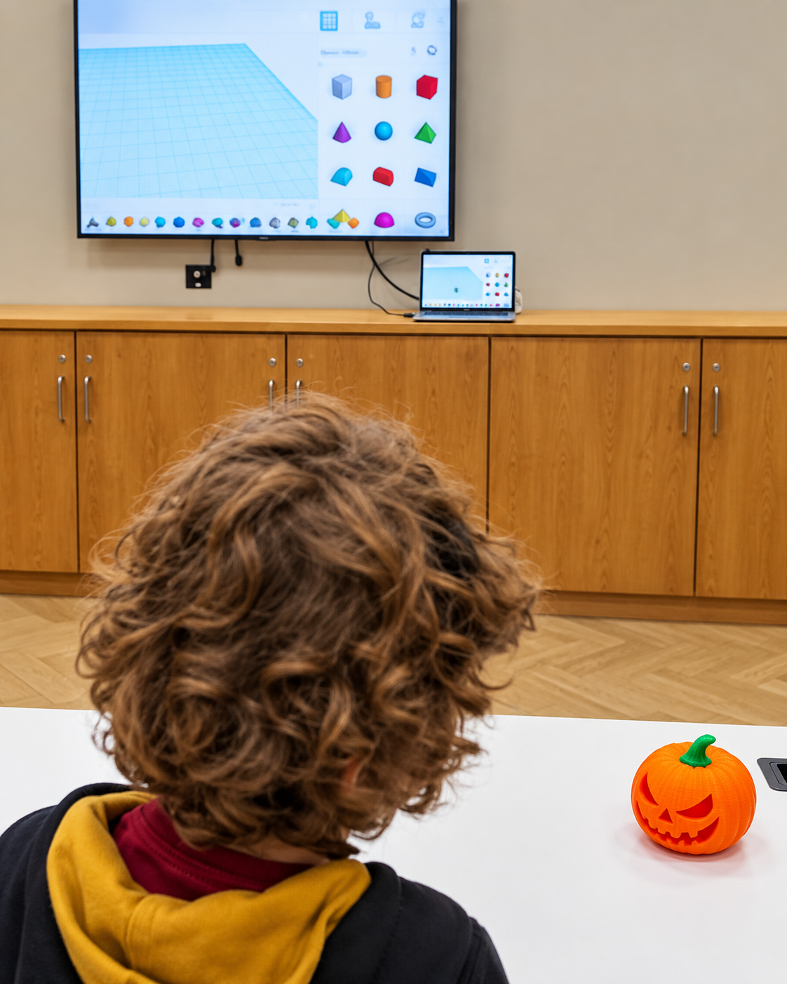Child designing a 3D printed Halloween pumpkin at an Epic Kids workshop.