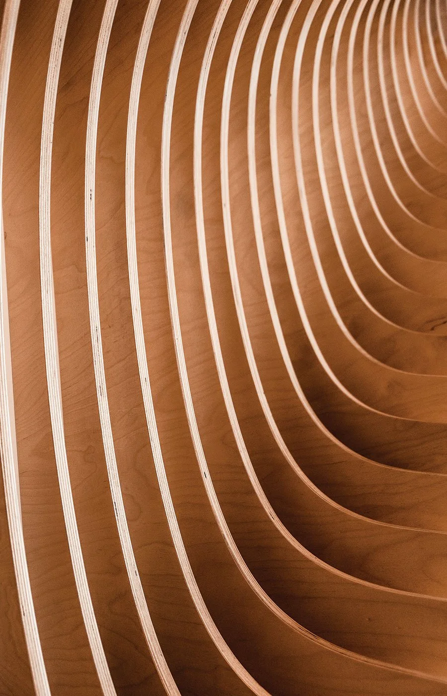 Close-up of curved wooden slats arranged in a wave-like pattern.