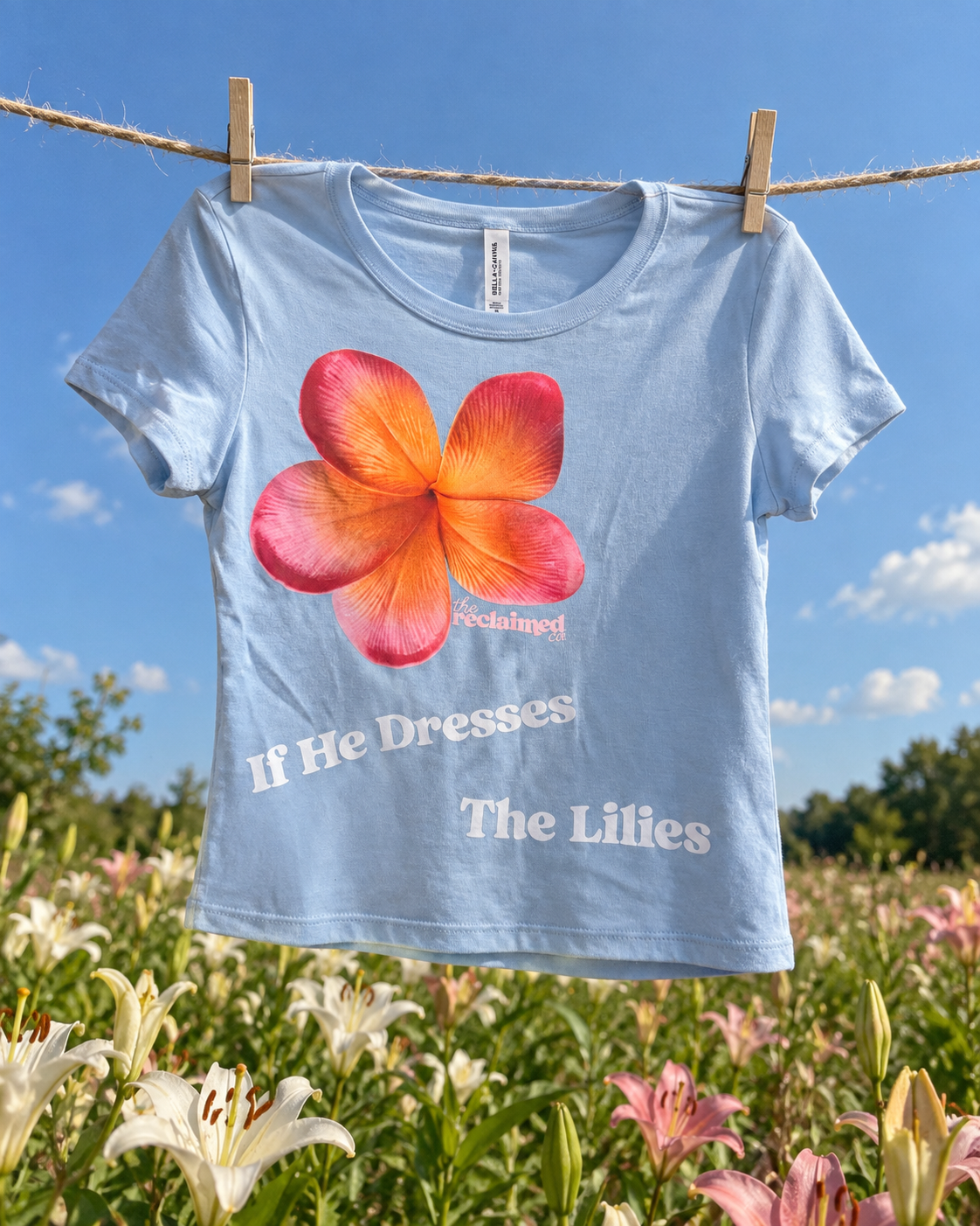 If He Dresses the Lilies Baby Tee 4.png