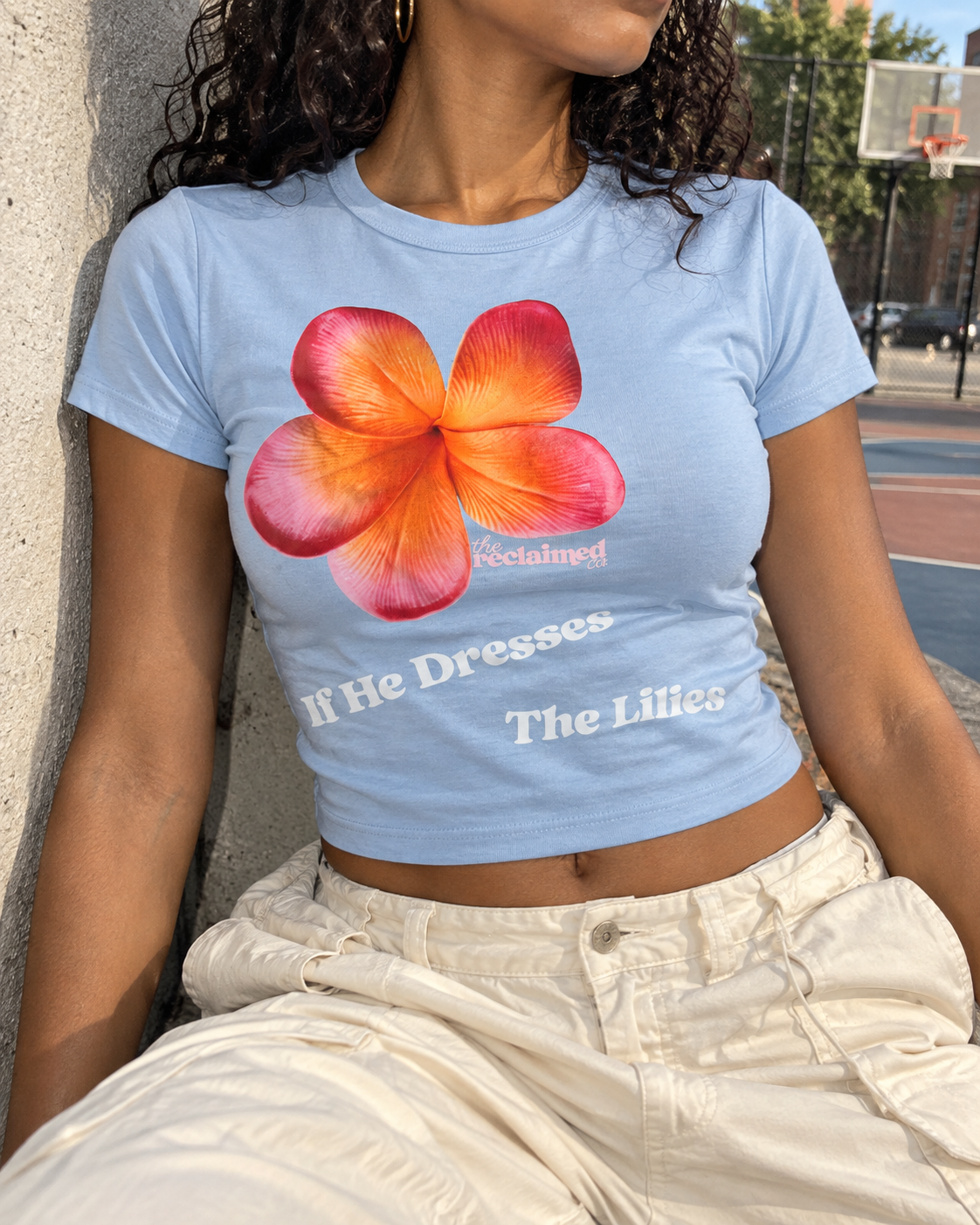 If He Dresses the Lilies Baby Tee 2.png