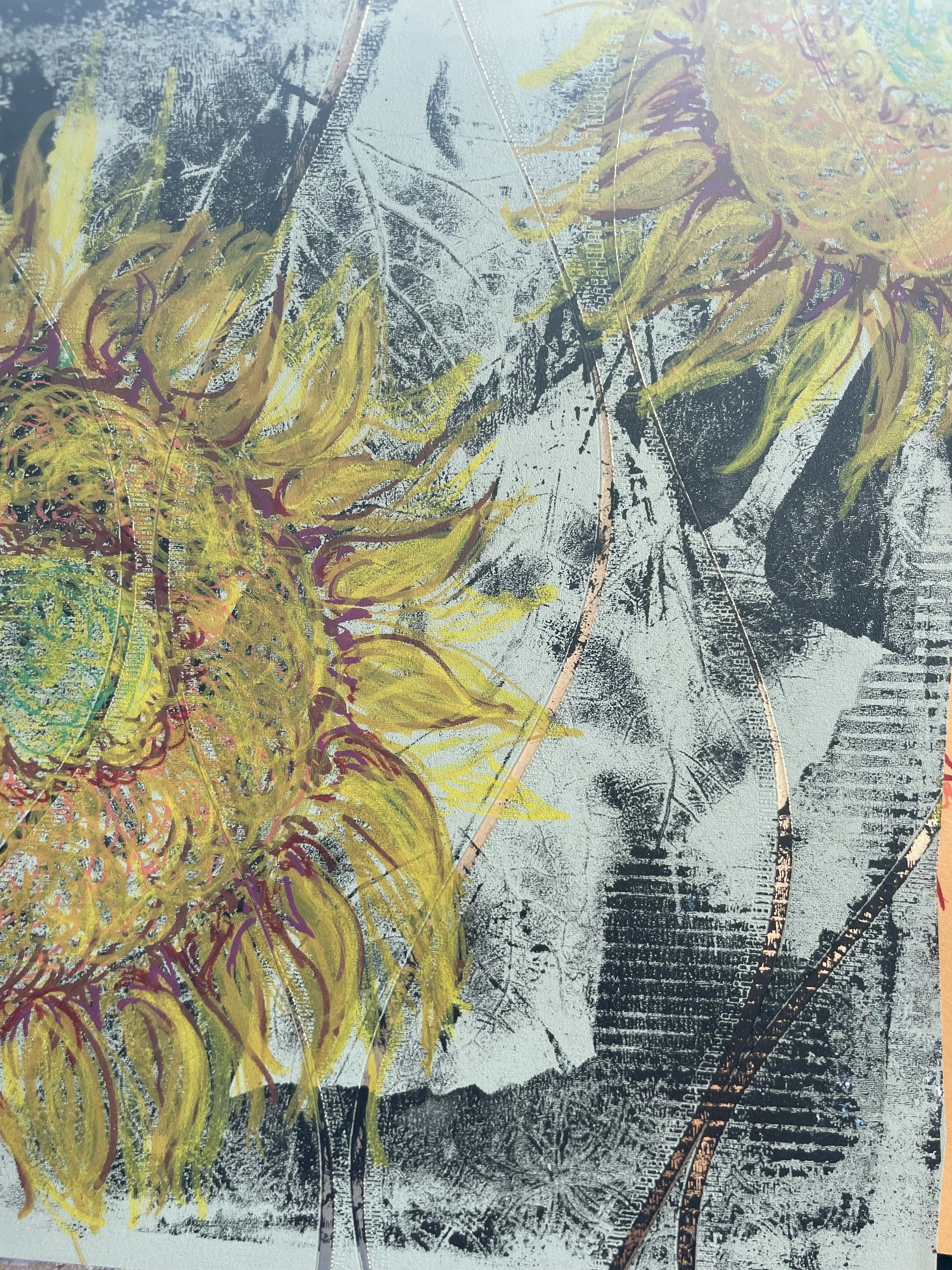 Close-up of a weathered surface with colorful abstract drawings and natural leaf patterns.