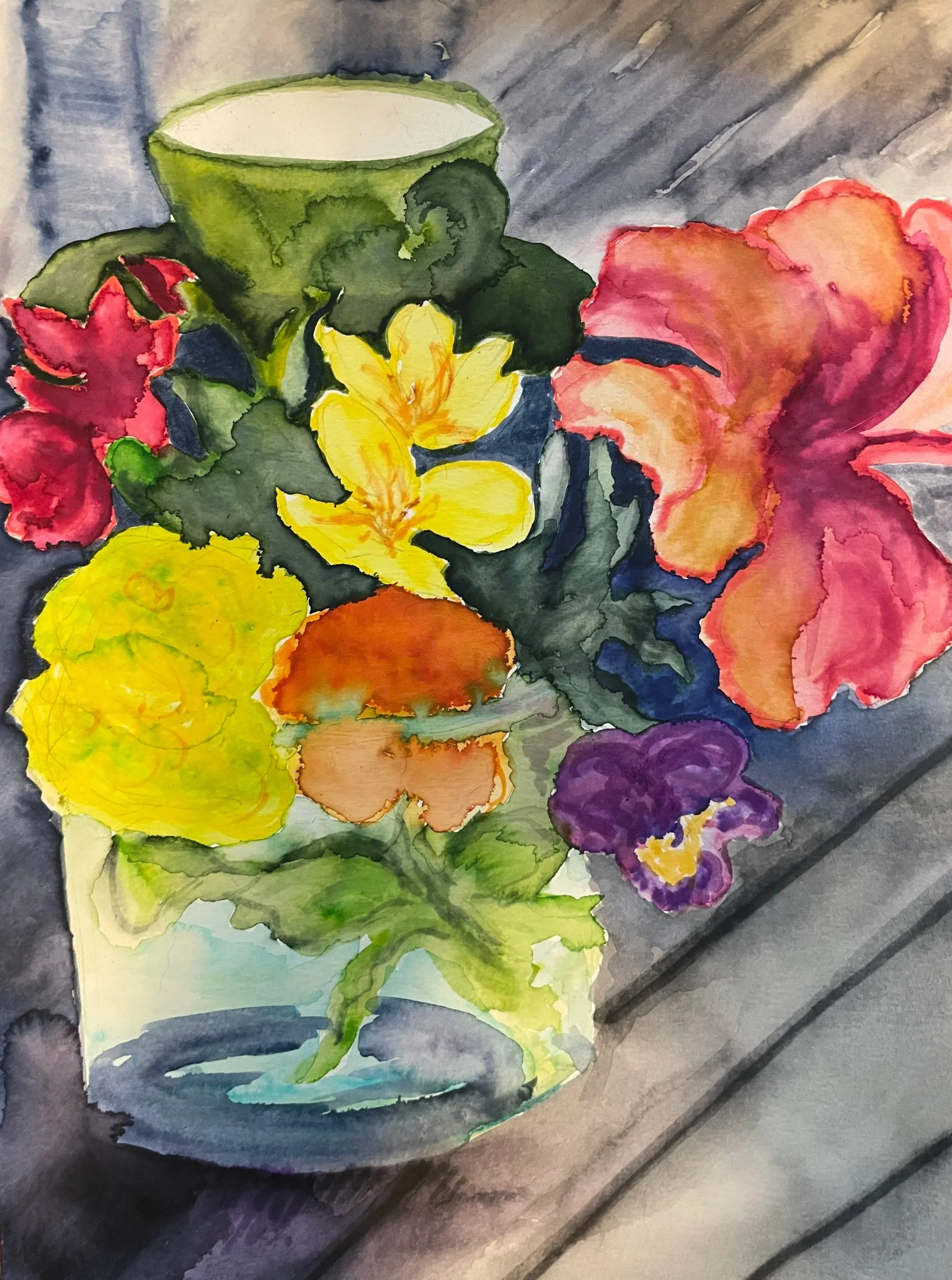 A colorful watercolor painting of a green cup filled with a beverage on a gray surface, surrounded by assorted vibrant flowers including purple, red, yellow, orange, and pink.