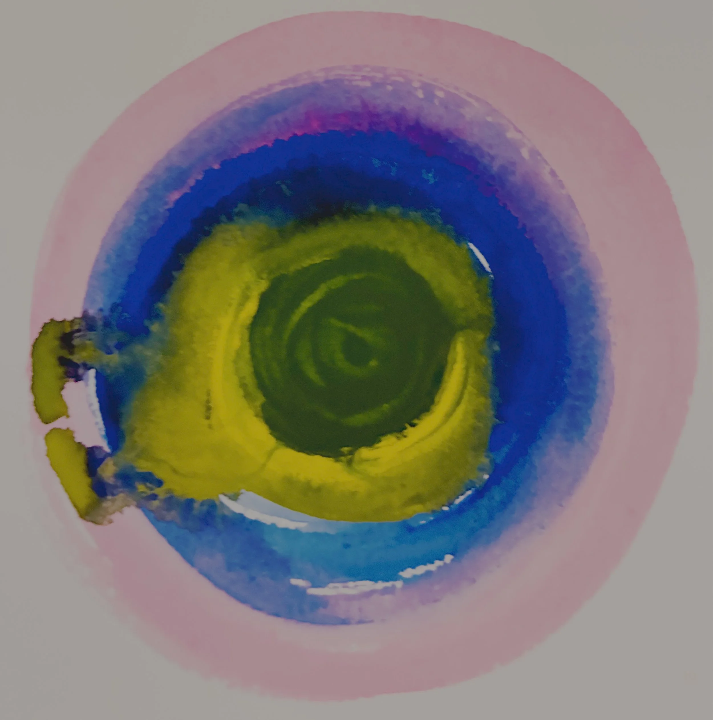 A colorful watercolor painting of concentric circles pooling into each other in a rainbow of tones from hot baby pink to deep rich cerulean blue, to yellow, to deep teal, loosely form a spiral pattern, with watercolor paints and inks spilling out.