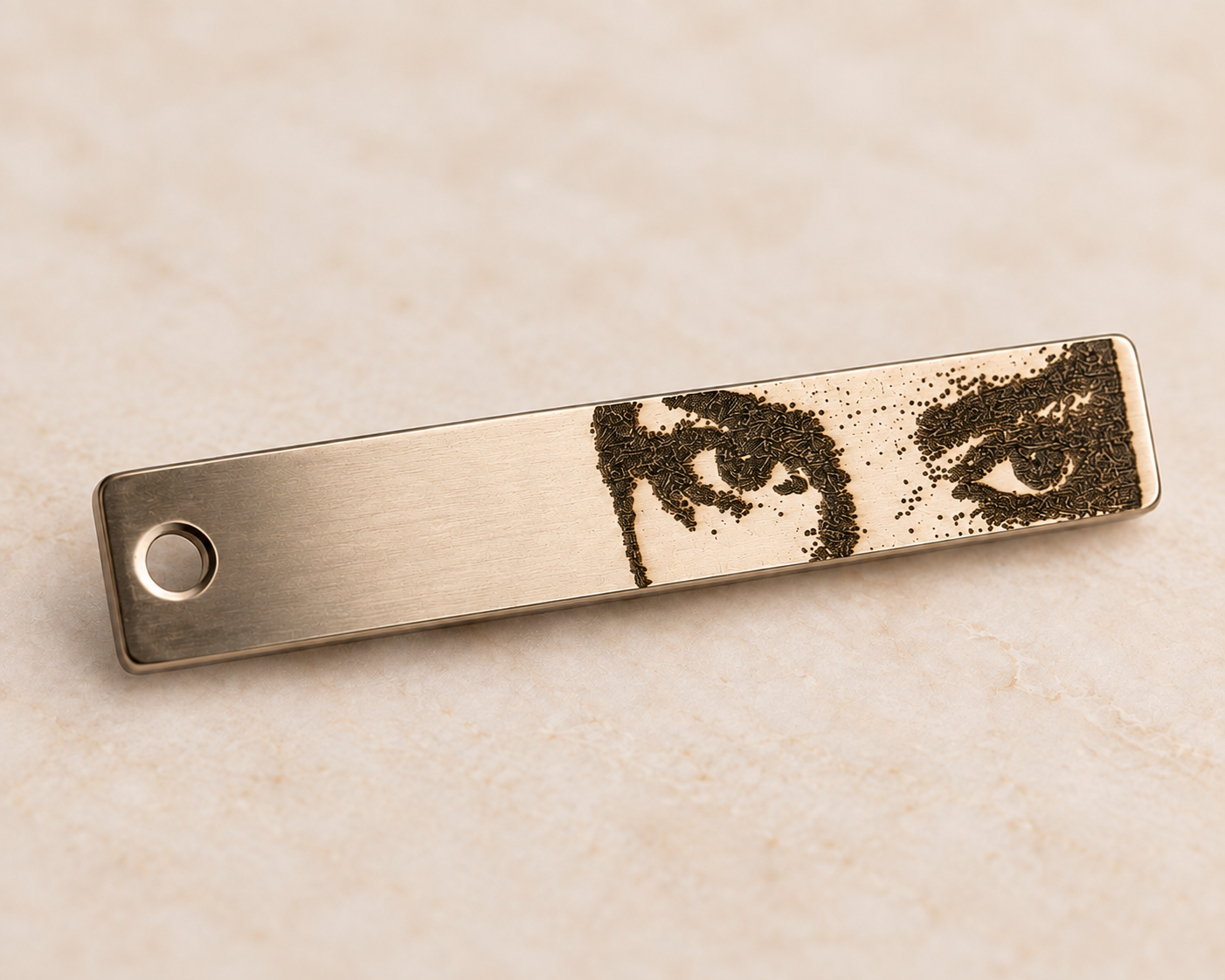 A metal object with an engraving of a person's eyes and hand on its surface.