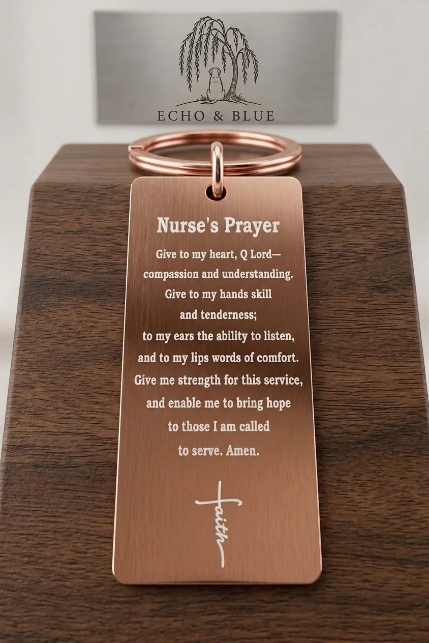 Copper-colored tag with a nurse's prayer on it, placed on a wooden surface, with a bracelet above it. In the background, there's a card with the logo of a tree and the text 'ECHO & BLUE.'