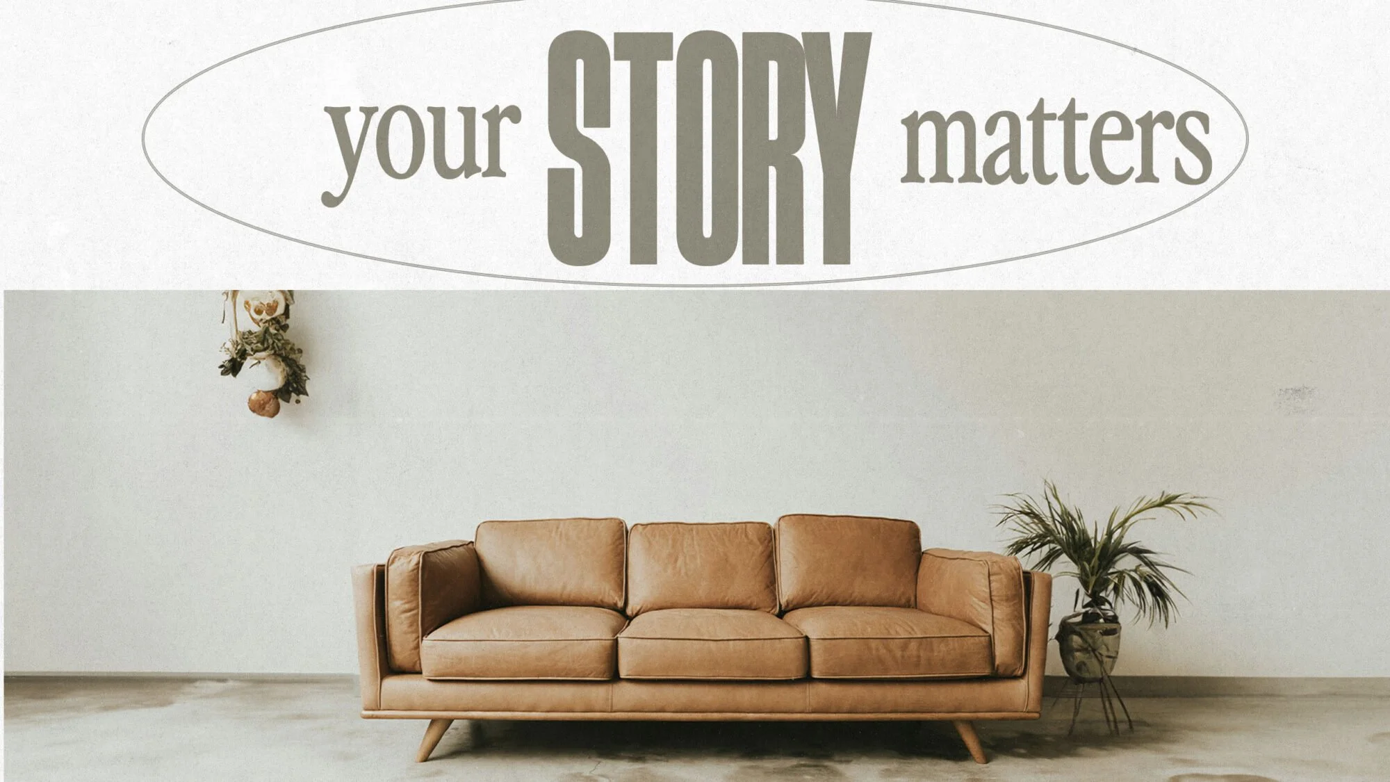 Living room with a light brown leather sofa, a potted plant, and a wall hanging with an eagle figure. A sign on the wall says 'your STORY matters'