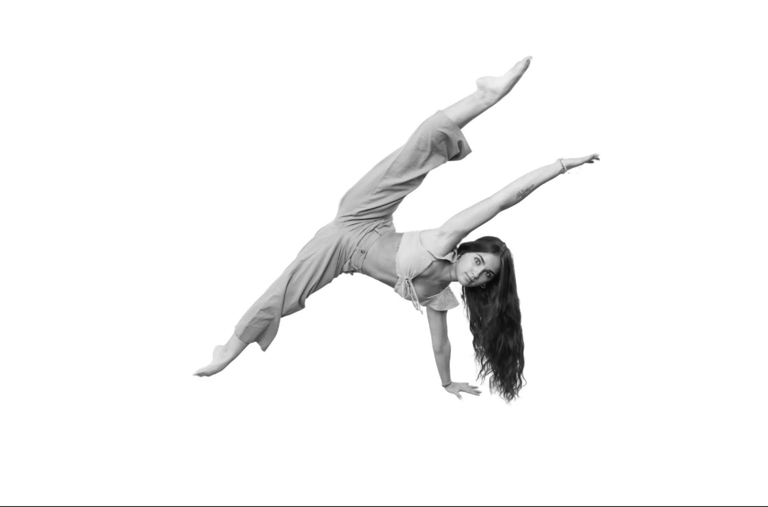 A woman performing a one-handed yoga pose against a white background.