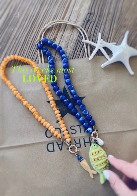 Blue and orange and yellow beaded fish necklaces with colorful fish pendants