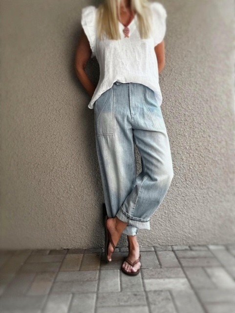 Banditas Nashi Jean vintage-washed light blue denim jeans styled in a relaxed pose with cuffed hem